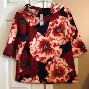 Women’s floral blouse; brand new.